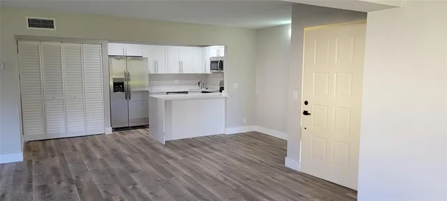 a view of kitchen with wooden floor