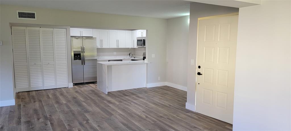 4829 Sable Pine Circle, Unit 1C West Palm Beach, FL 33417 - Photo 7 of 16 a view of kitchen with wooden floor