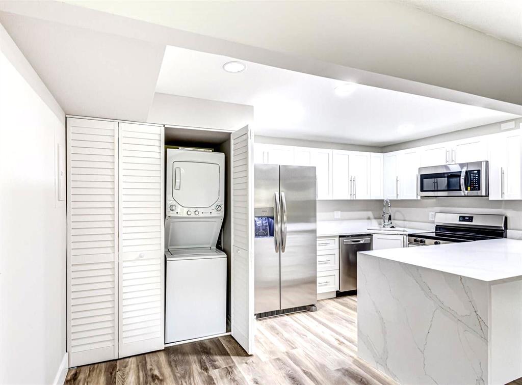 4829 Sable Pine Circle, Unit 1C West Palm Beach, FL 33417 - Photo 8 of 16 a kitchen with a refrigerator and a stove