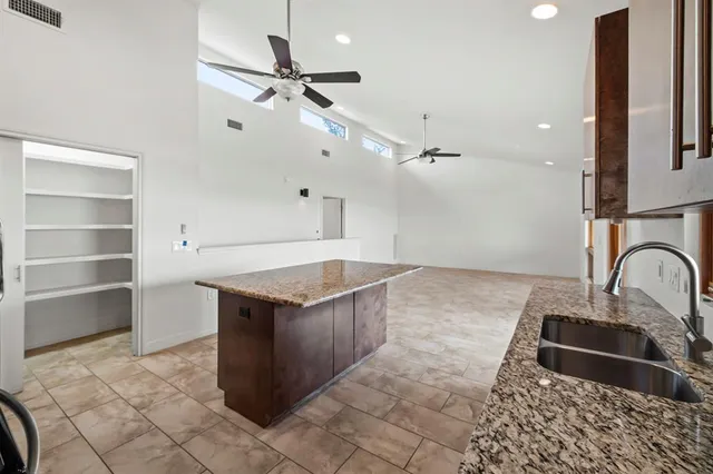 a kitchen with a sink cabinets and wooden floor