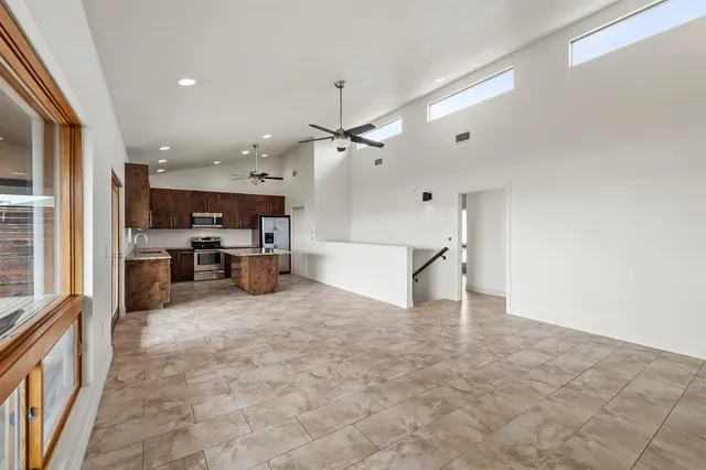 a view of a kitchen with furniture and a ceiling fan