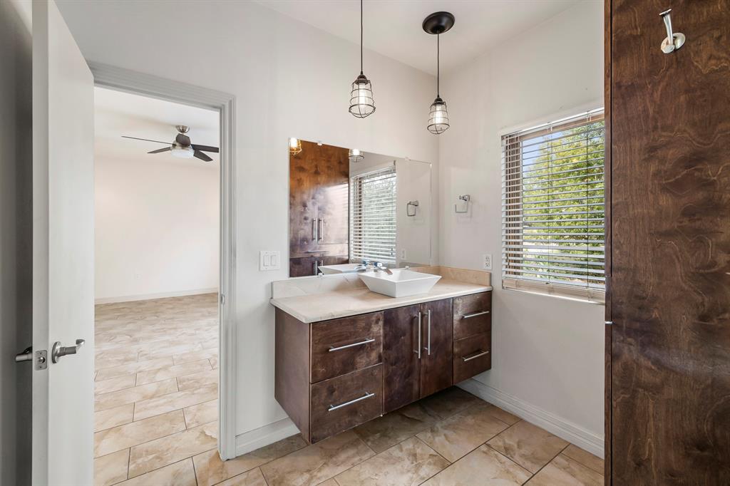 3160 Thurman Road, Unit A Lago Vista, TX 78645 - Photo 23 of 30 a bathroom with a sink a vanity and a mirror
