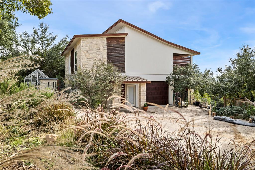 3160 Thurman Road, Unit A Lago Vista, TX 78645 - Photo 5 of 30 a front view of house with yard and trees in the background