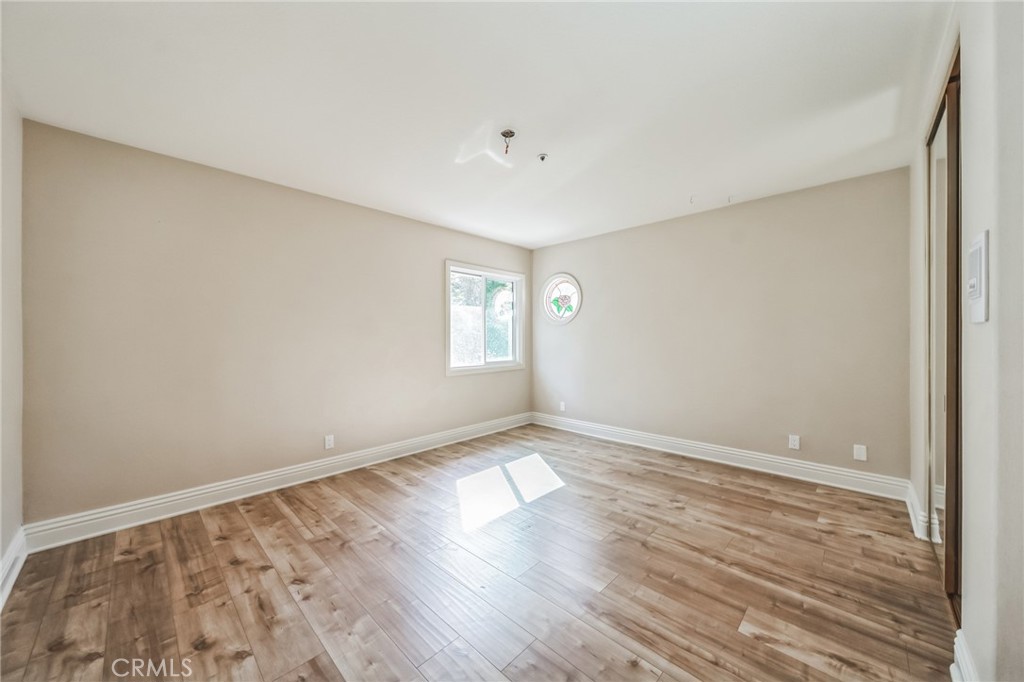 1432 Rutherford Drive Pasadena, CA 91103 - Photo 13 of 33 an empty room with wooden floor and windows