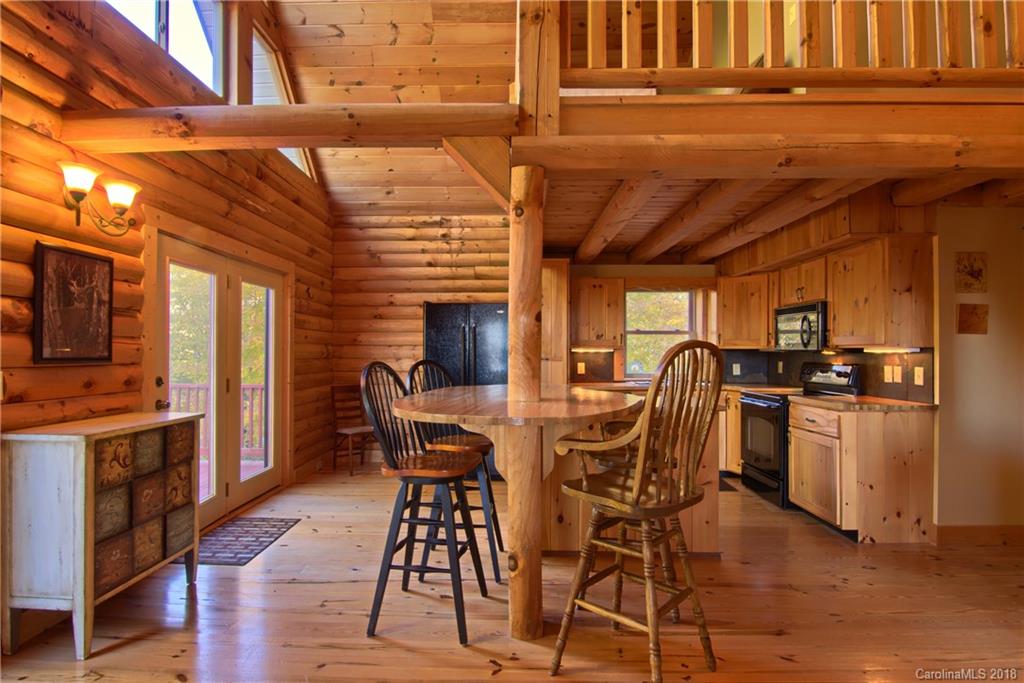 548 Miller Branch Road Mars Hill, NC 28754 - Photo 11 of 35 a view of a dining room with furniture window and wooden floor