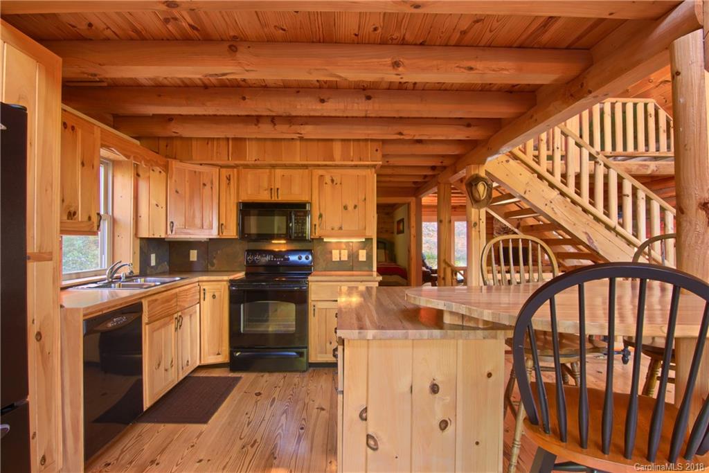 548 Miller Branch Road Mars Hill, NC 28754 - Photo 12 of 35 a kitchen with stainless steel appliances granite countertop a stove and a refrigerator
