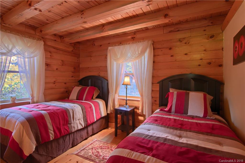 548 Miller Branch Road Mars Hill, NC 28754 - Photo 16 of 35 a bedroom with 2 bed and a lamp