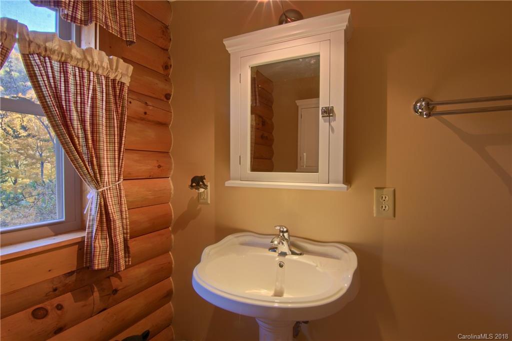 548 Miller Branch Road Mars Hill, NC 28754 - Photo 18 of 35 a bathroom with a sink and a mirror