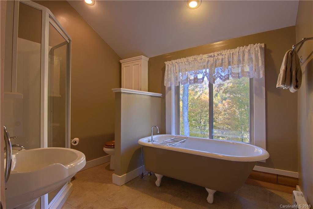 548 Miller Branch Road Mars Hill, NC 28754 - Photo 24 of 35 a bedroom with a bed and a window
