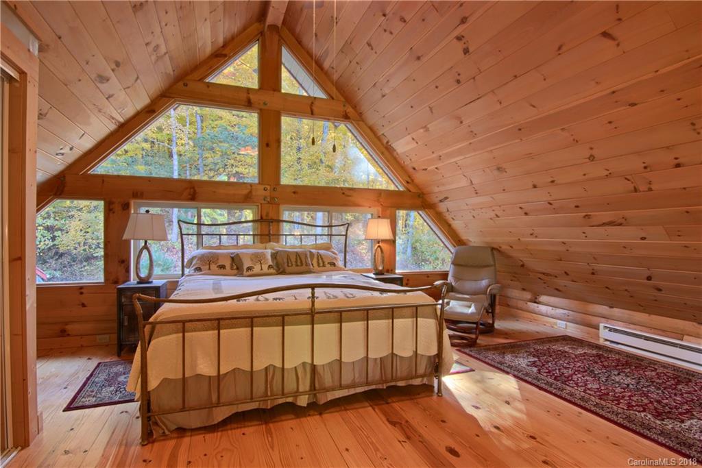 548 Miller Branch Road Mars Hill, NC 28754 - Photo 25 of 35 a bedroom with a bed and a large window