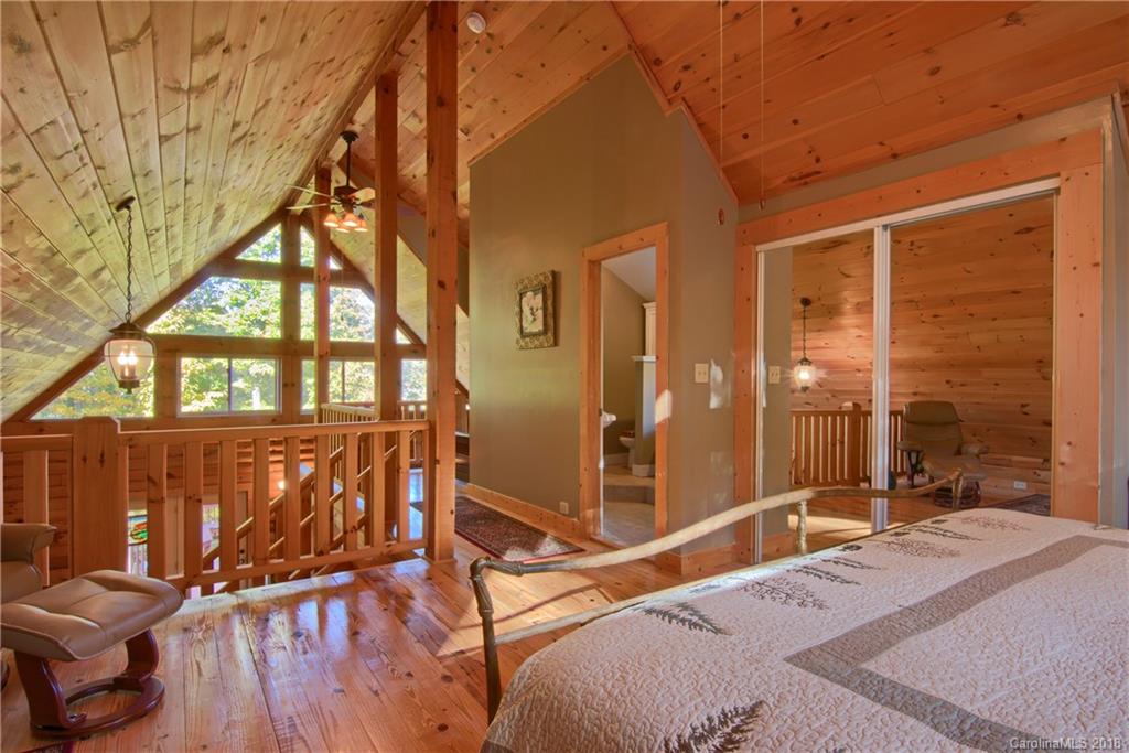 548 Miller Branch Road Mars Hill, NC 28754 - Photo 27 of 35 a bedroom with a bed and wooden floor