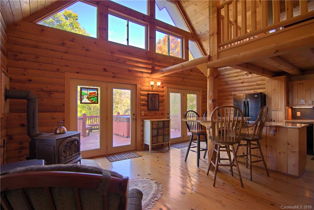 548 Miller Branch Road Mars Hill, NC 28754 - Photo 10 of 35 a living room with furniture a wooden floor and chandelier