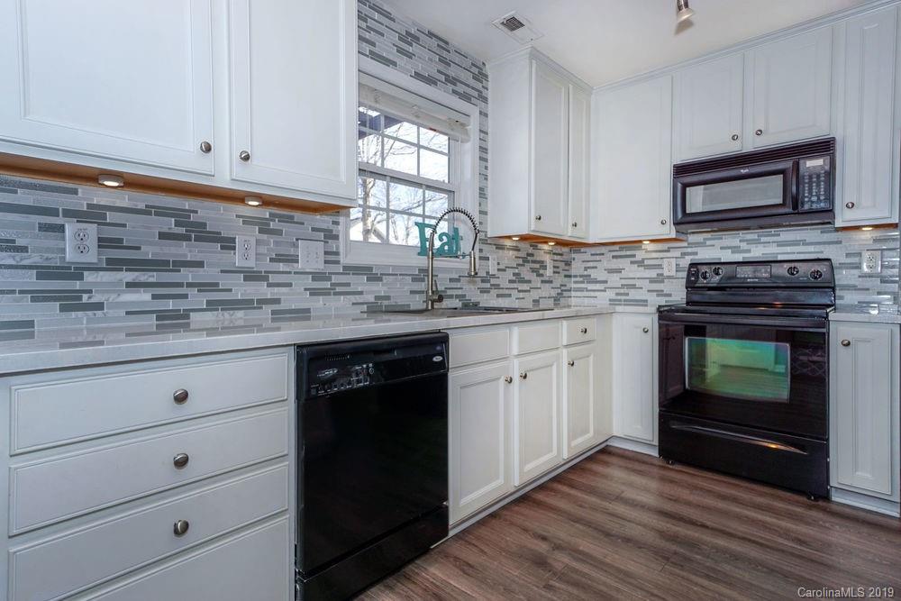 10029 Caldwell Depot Road Cornelius, NC 28031 - Photo 17 of 34 a kitchen with white cabinets and appliances