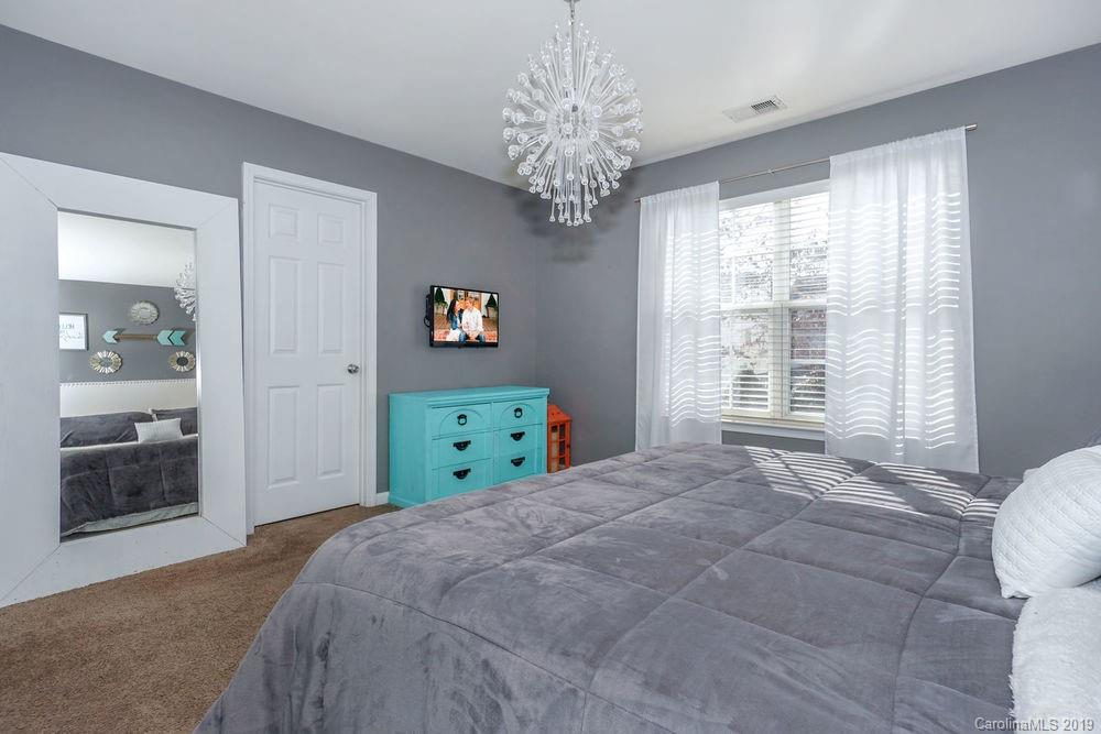 10029 Caldwell Depot Road Cornelius, NC 28031 - Photo 21 of 34 a bedroom with a bed and a window