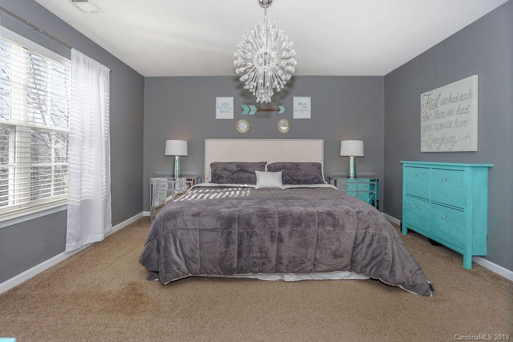 10029 Caldwell Depot Road Cornelius, NC 28031 - Photo 23 of 34 a spacious bedroom with a bed and a window