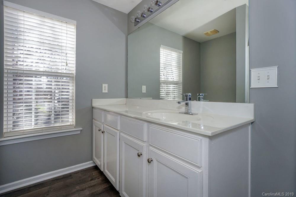 10029 Caldwell Depot Road Cornelius, NC 28031 - Photo 25 of 34 a bathroom with a granite countertop sink and a window
