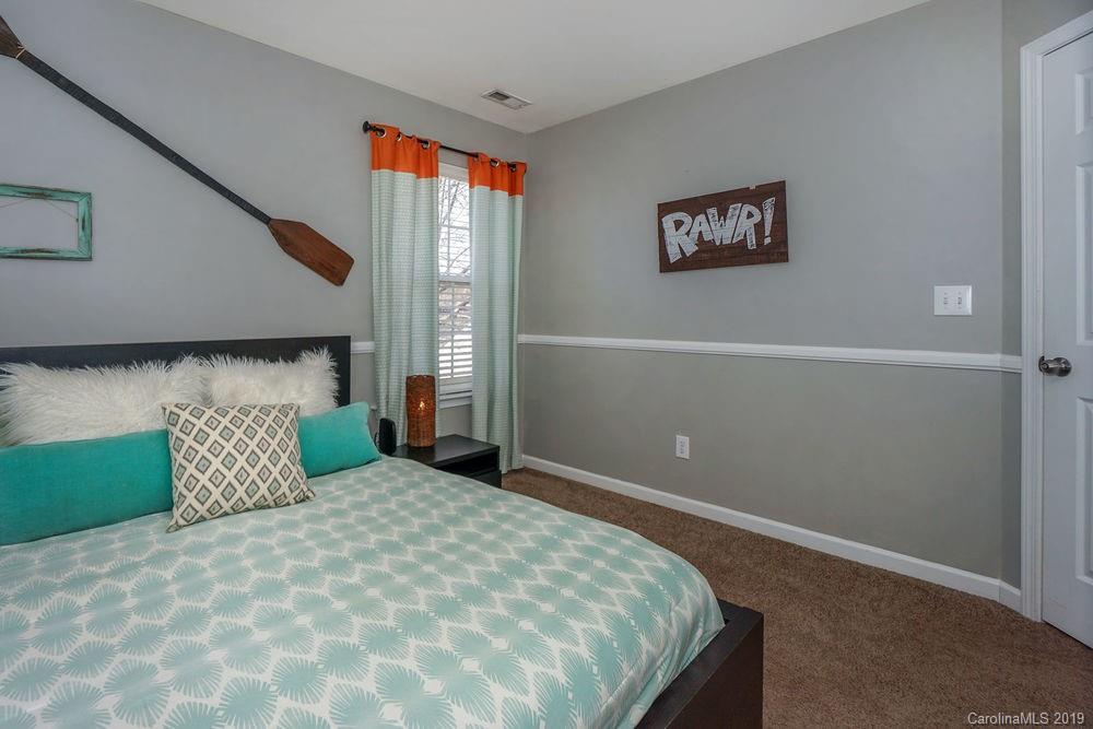 10029 Caldwell Depot Road Cornelius, NC 28031 - Photo 26 of 34 a bedroom with a bed and a painting on the wall