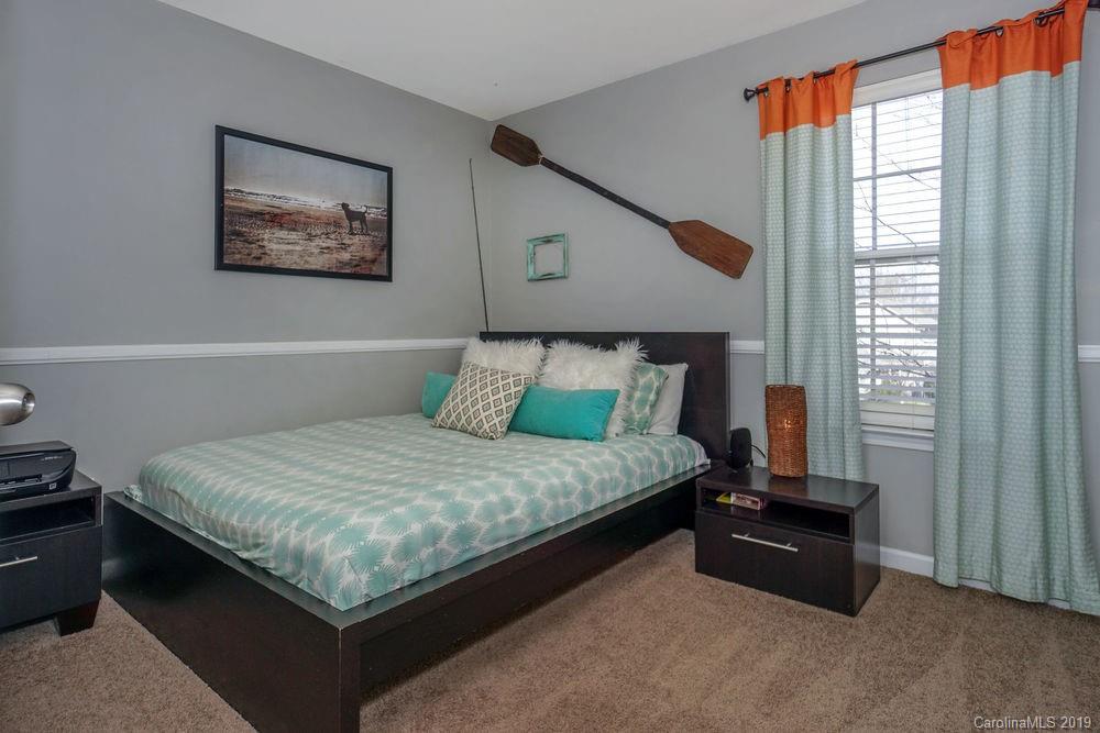 10029 Caldwell Depot Road Cornelius, NC 28031 - Photo 27 of 34 a bed sitting in a bedroom next to a window