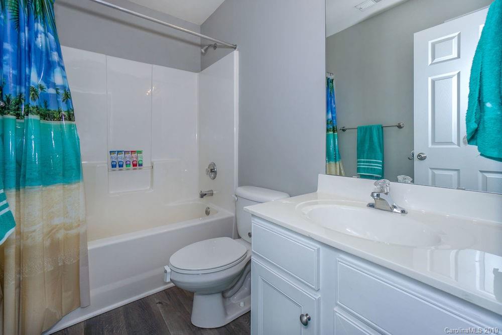 10029 Caldwell Depot Road Cornelius, NC 28031 - Photo 30 of 34 a bathroom with a sink a toilet and a bathtub