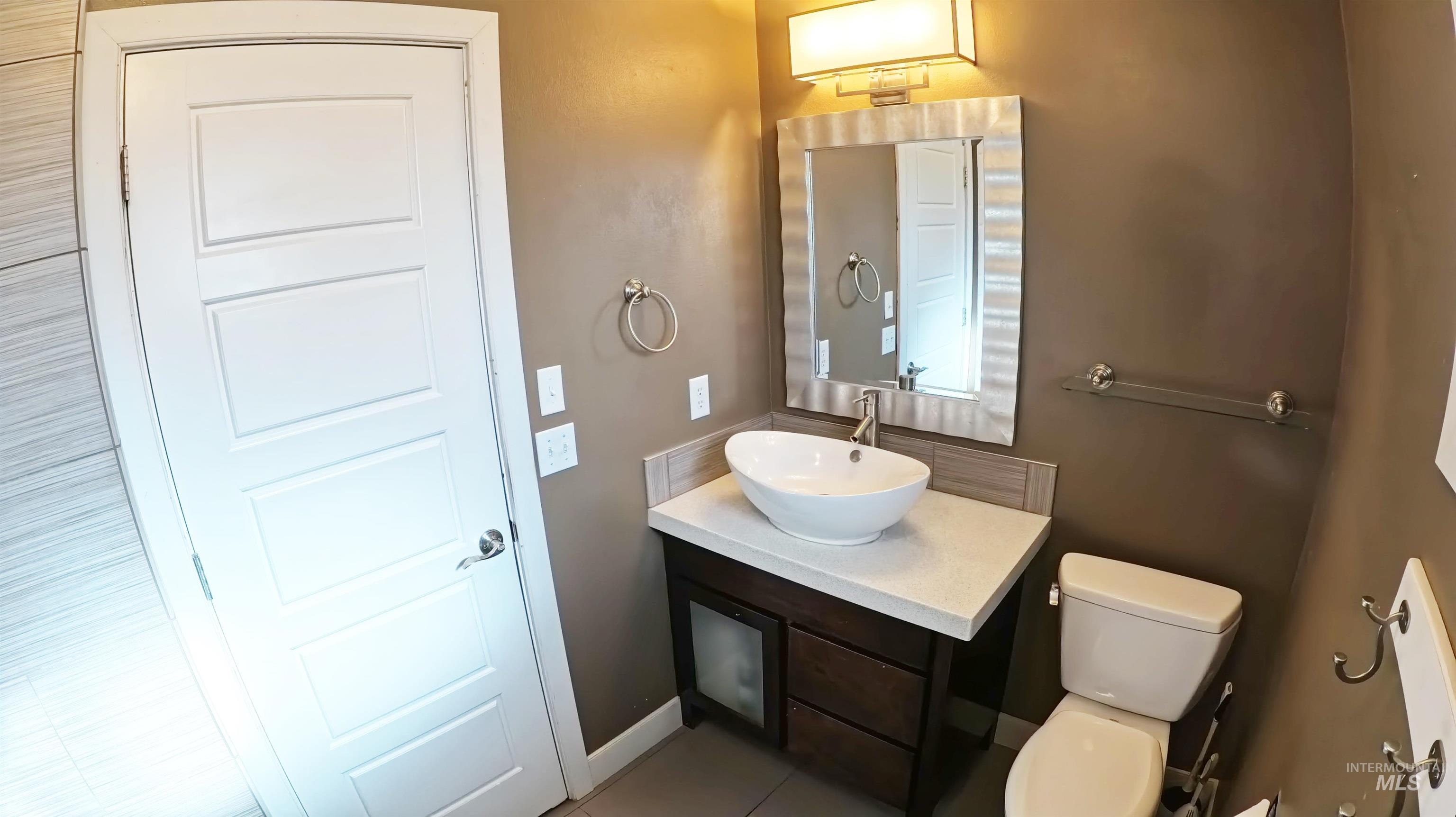 223 Hillcrest Road Burley, ID 83318 - Photo 19 of 27 Half bathroom featuring vanity and light tile patterned floors