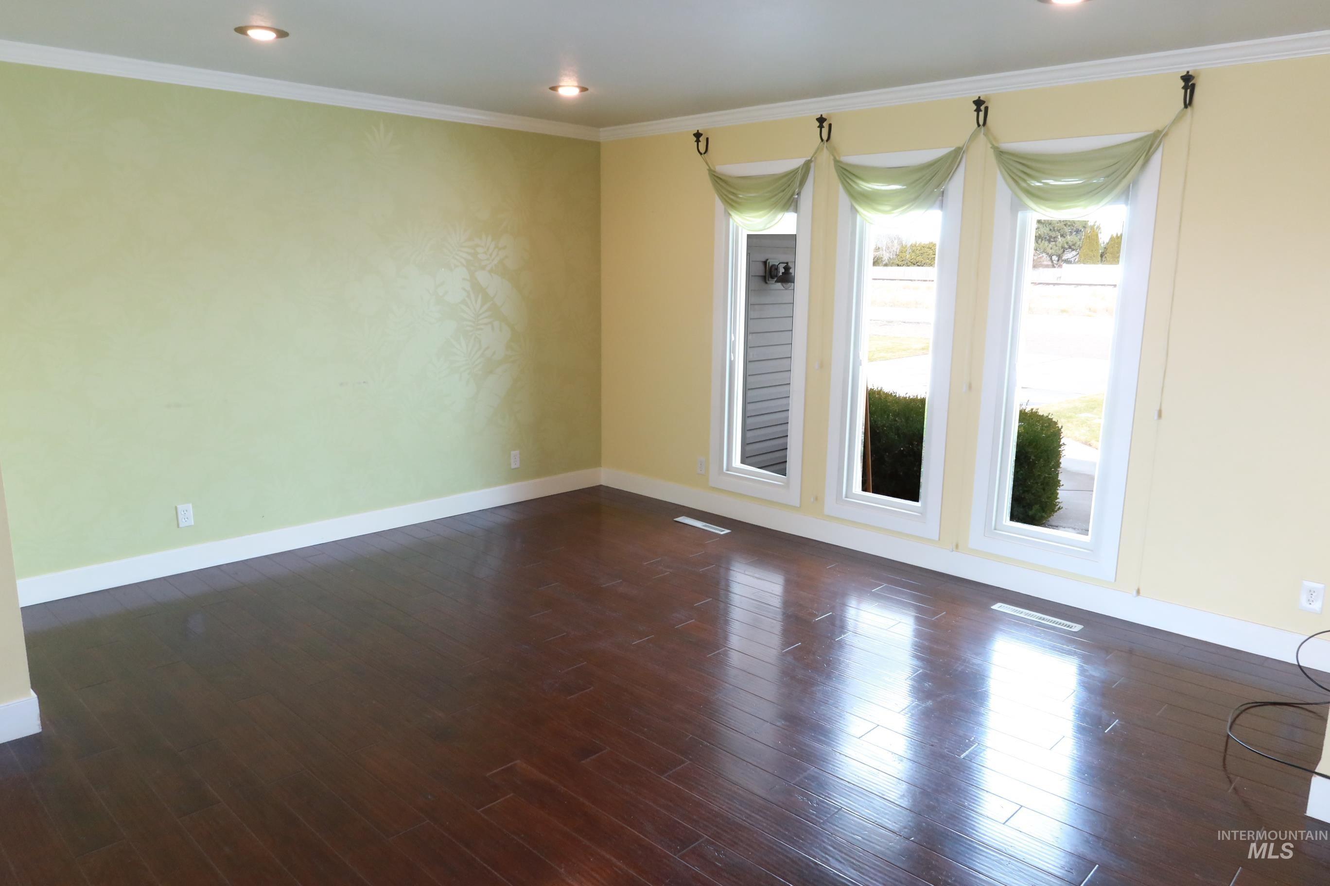 223 Hillcrest Road Burley, ID 83318 - Photo 7 of 27 Spare room featuring dark wood-style floors, ornamental molding, and recessed lighting