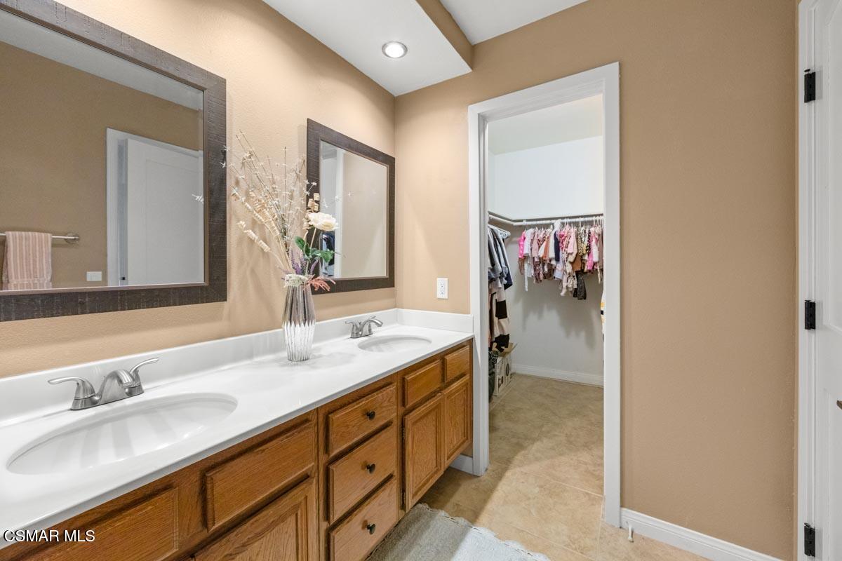 3918 Cochran Street, Unit 19 Simi Valley, CA 93063 - Photo 13 of 22 a en suite bathroom with a double vanity sink and mirror