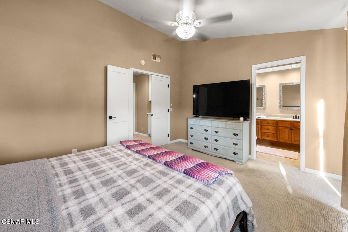 3918 Cochran Street, Unit 19 Simi Valley, CA 93063 - Photo 15 of 22 a bedroom with a bed and a flat screen tv