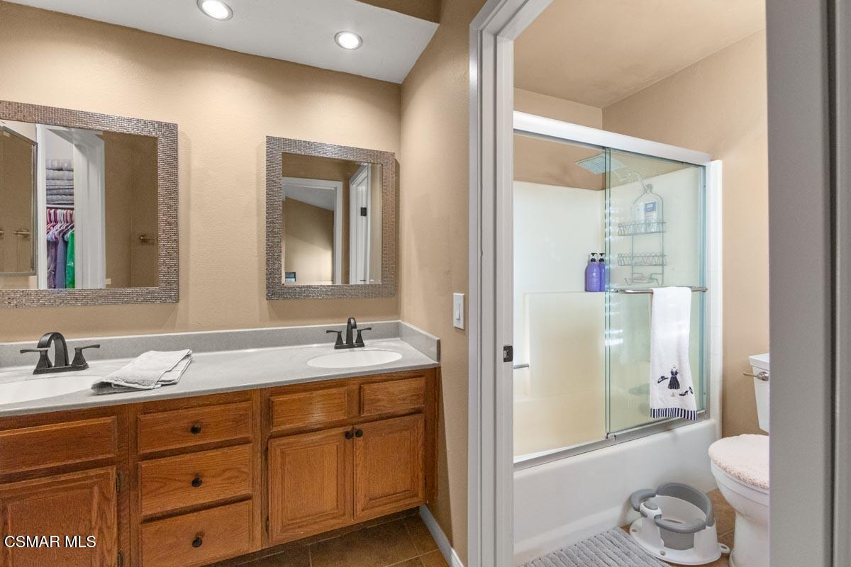 3918 Cochran Street, Unit 19 Simi Valley, CA 93063 - Photo 16 of 22 a bathroom with a granite countertop sink toilet and shower