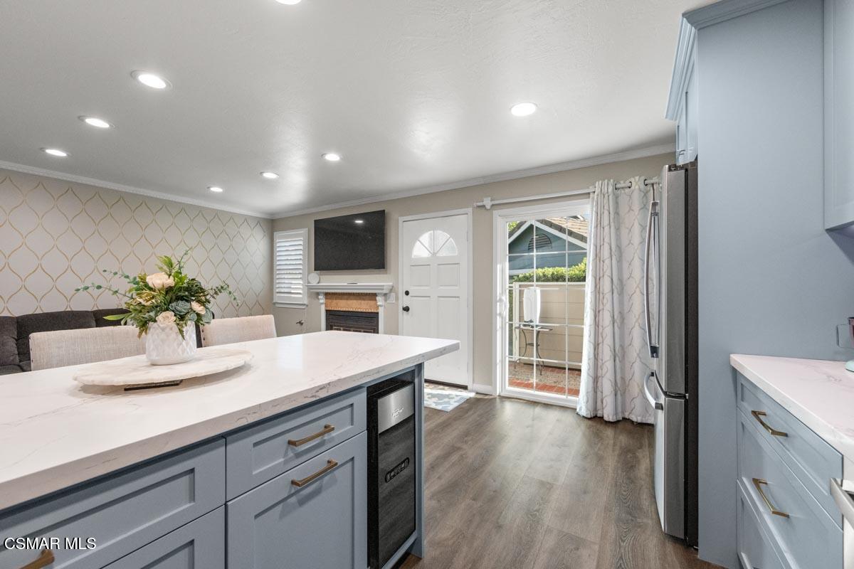 3918 Cochran Street, Unit 19 Simi Valley, CA 93063 - Photo 5 of 22 a view of kitchen with sink microwave refrigerator and living room