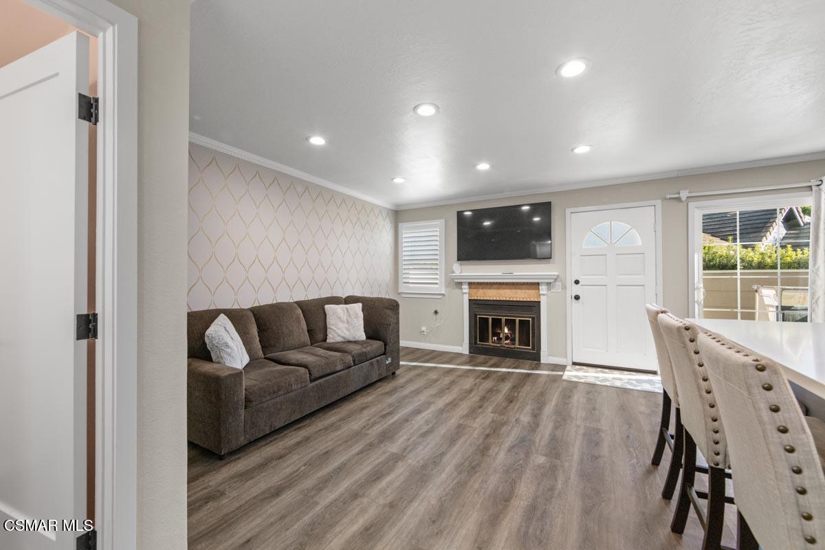 3918 Cochran Street, Unit 19 Simi Valley, CA 93063 - Photo 7 of 22 a living room with furniture a fireplace and a flat screen tv