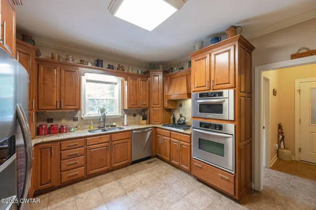 a kitchen with a sink stove and window