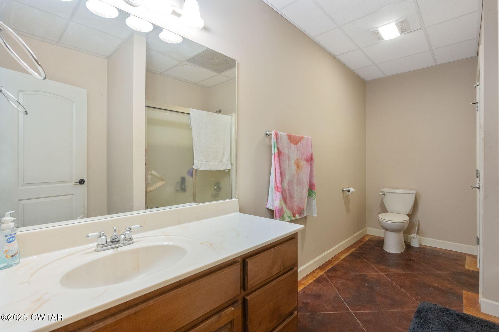 2400 Sand Ridge Bargerton Road Lexington, TN 38351 - Photo 29 of 48 a bathroom with a sink a toilet and a mirror