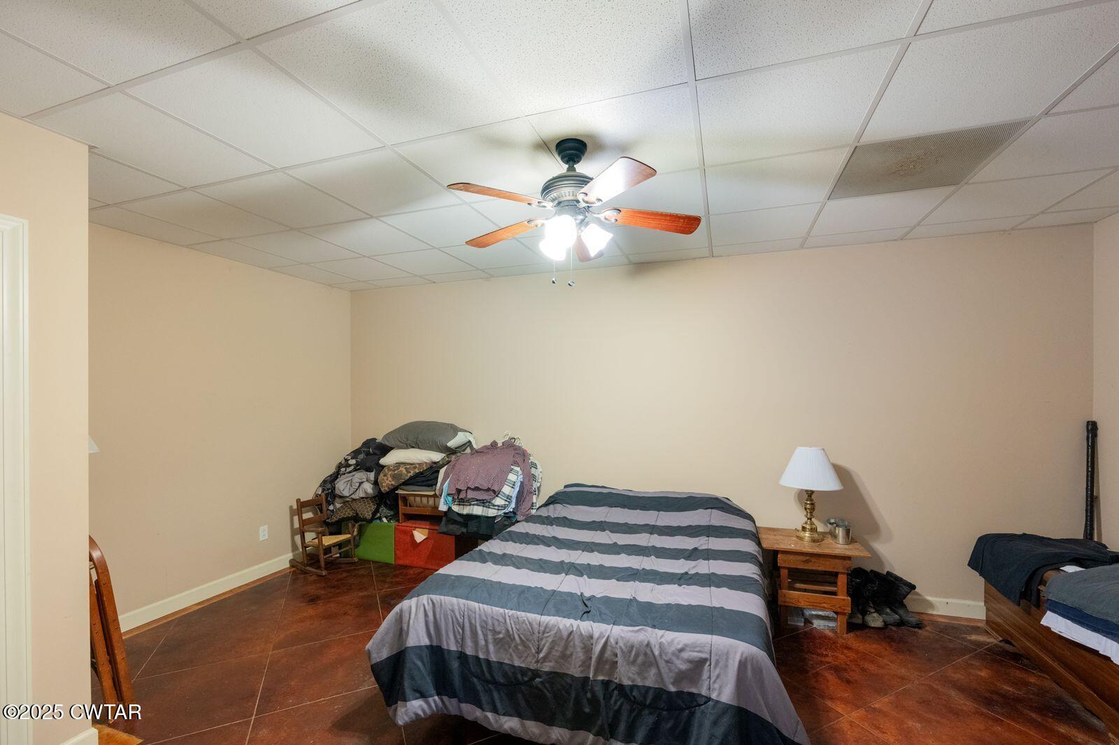 2400 Sand Ridge Bargerton Road Lexington, TN 38351 - Photo 30 of 48 a bedroom with bed and a chandelier