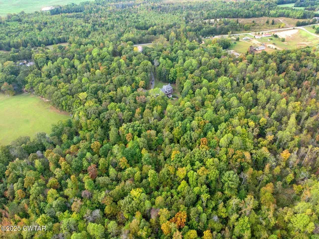 an aerial view of a houses with a yard