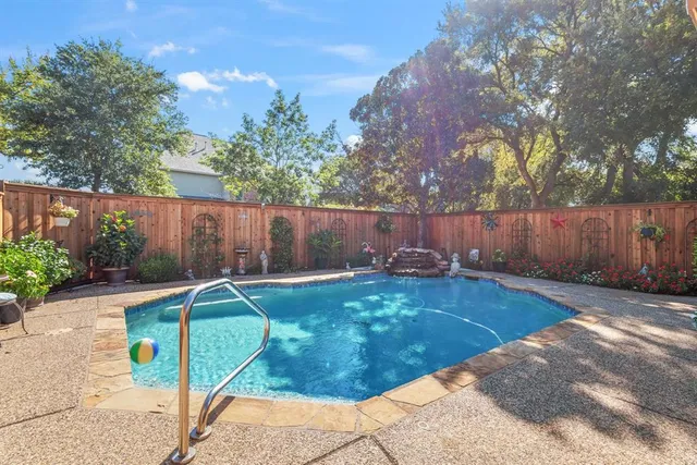 a view of a backyard with table and chairs and wooden fence