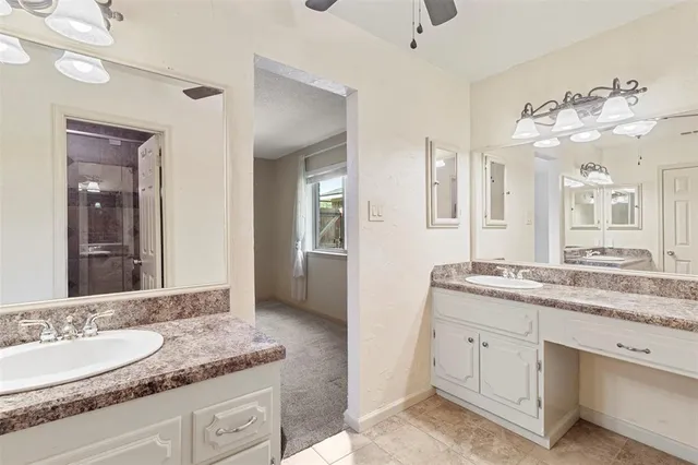 a bathroom with a granite countertop sink mirror and double