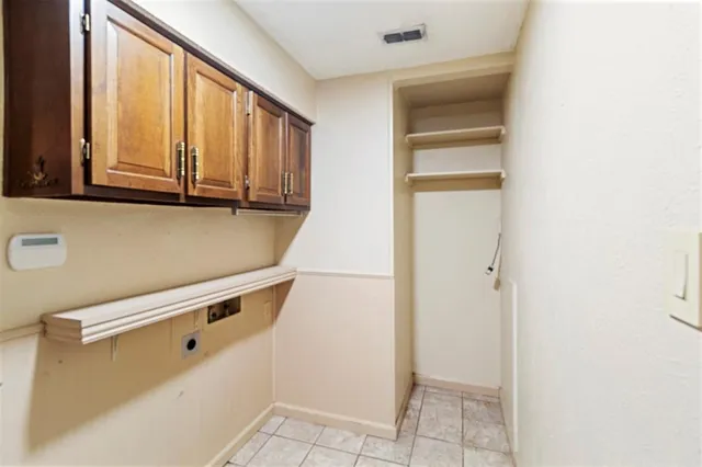 a view of a kitchen with white cabinets