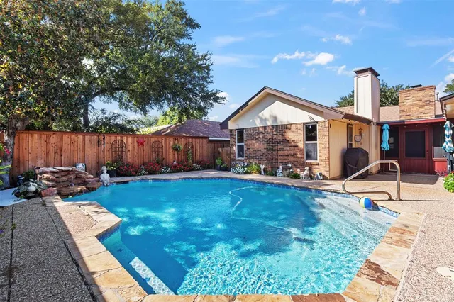 an aerial view of a house with yard swimming pool and outdoor seating