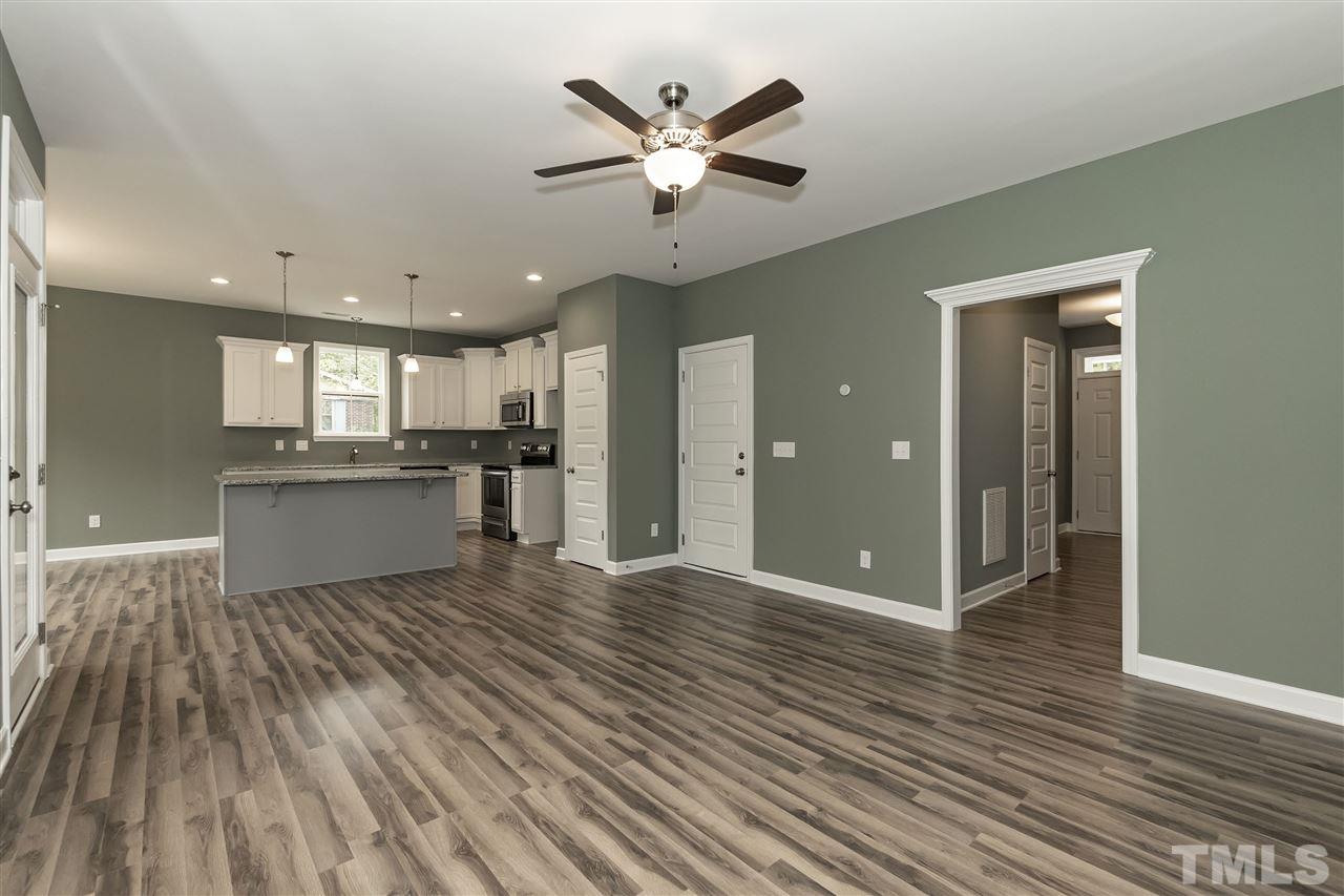 3430 Dutchman Road Raleigh, NC 27610 - Photo 18 of 21 a view of an empty room with wooden floor and a ceiling fan