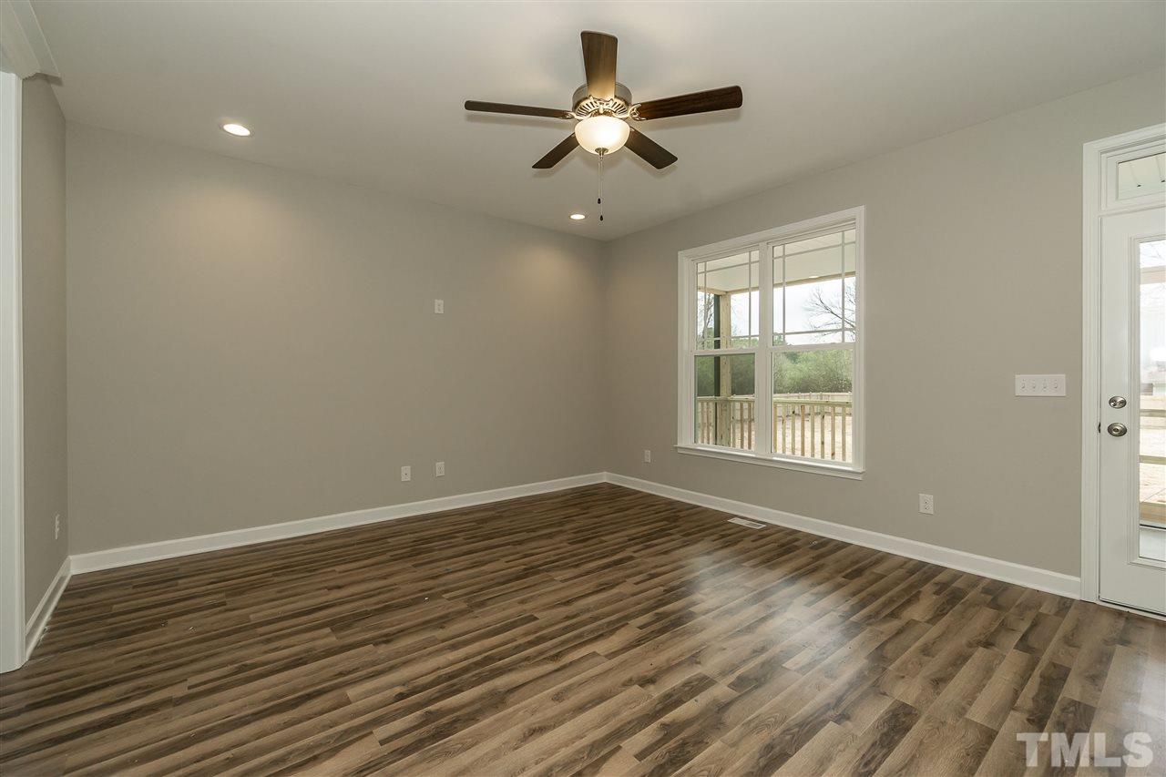3430 Dutchman Road Raleigh, NC 27610 - Photo 20 of 21 a view of an empty room with wooden floor and a window