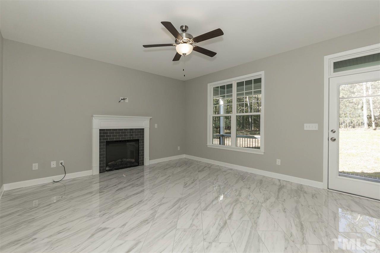 3430 Dutchman Road Raleigh, NC 27610 - Photo 3 of 21 a view of an empty room with wooden floor and a window