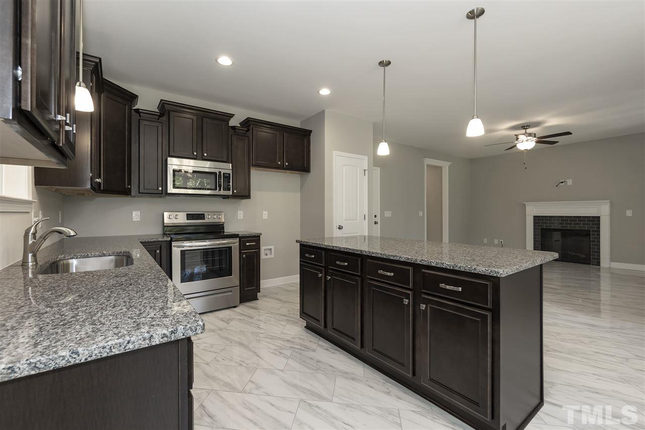 3430 Dutchman Road Raleigh, NC 27610 - Photo 5 of 21 a kitchen with stainless steel appliances granite countertop a sink wooden cabinets and a granite counter tops