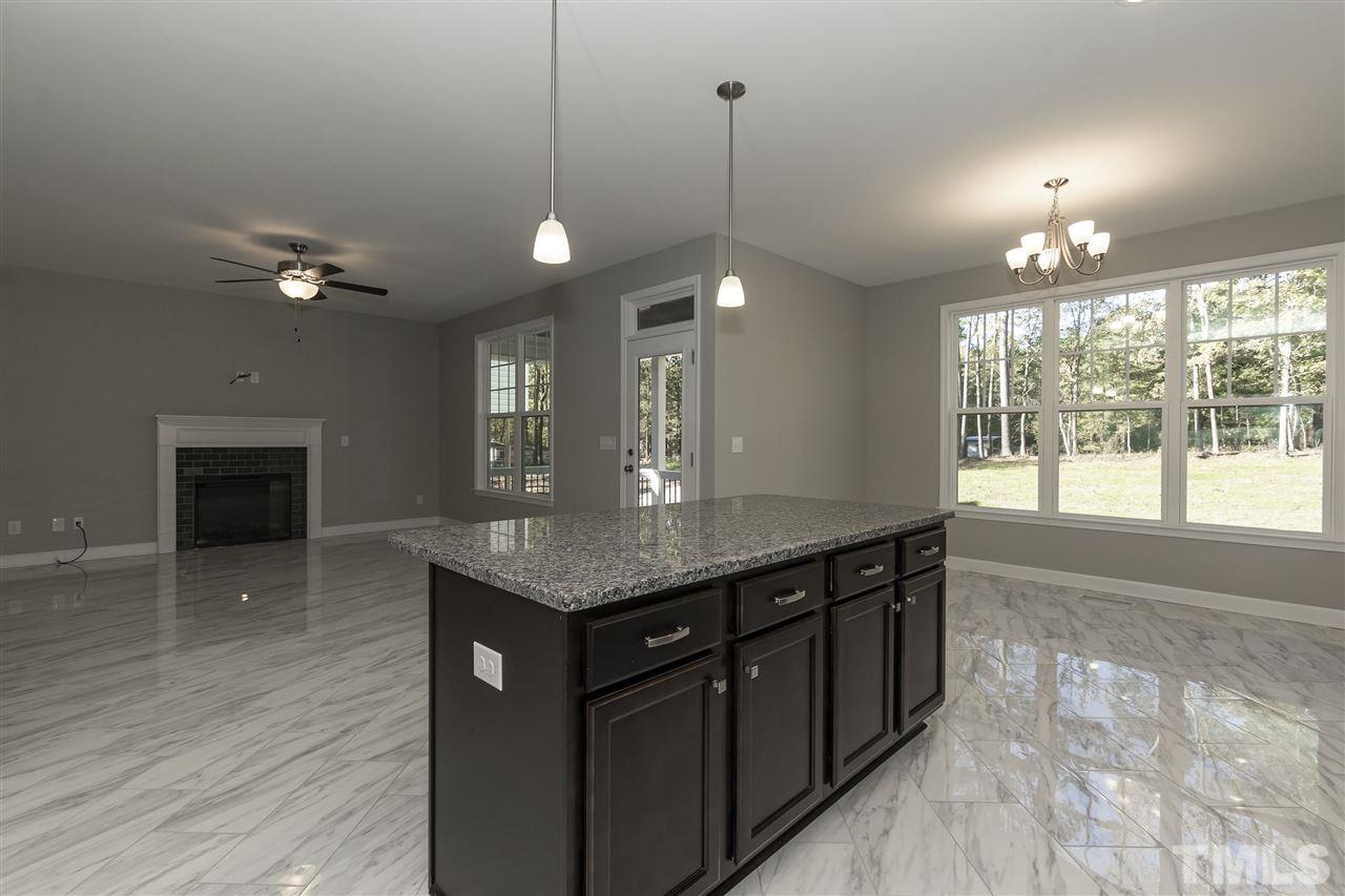 3430 Dutchman Road Raleigh, NC 27610 - Photo 6 of 21 a kitchen with a stove a sink and wooden floor