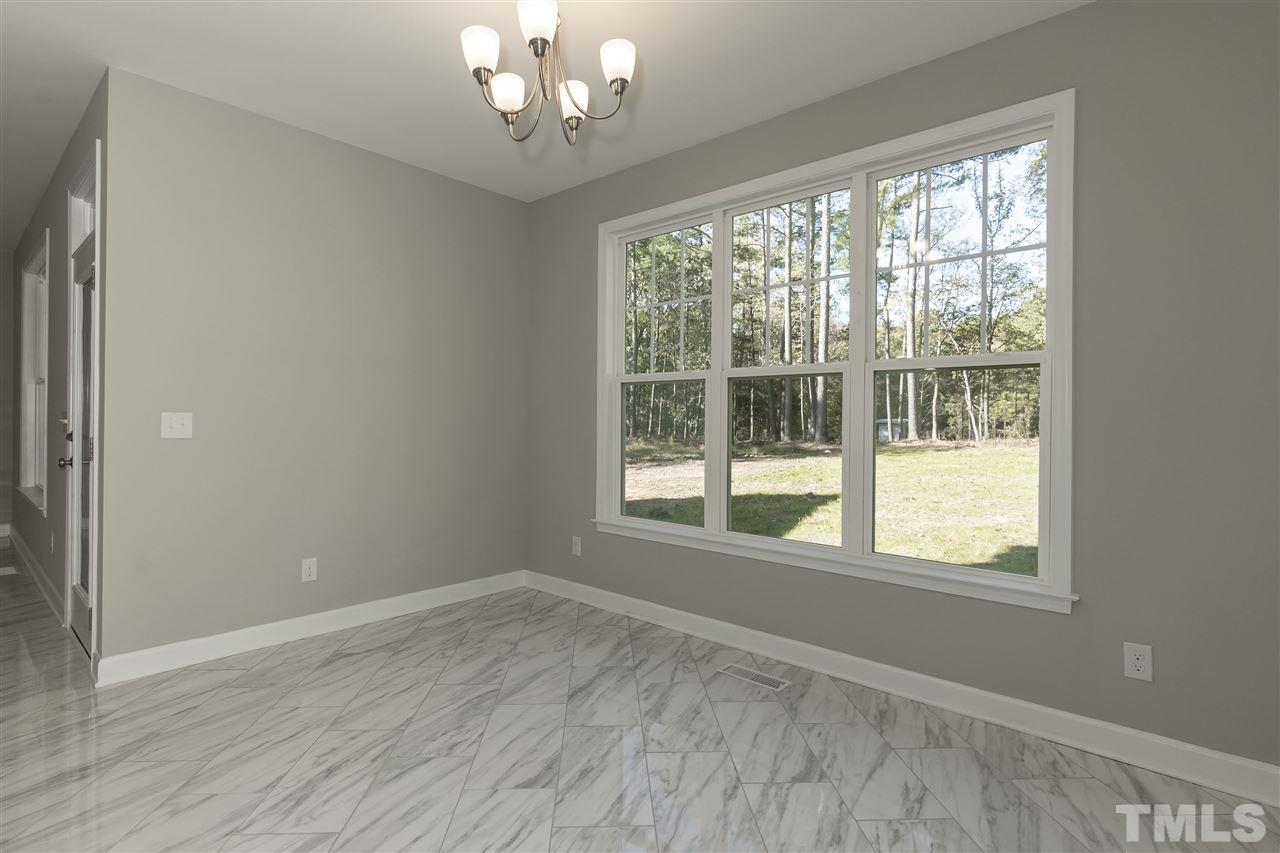 3430 Dutchman Road Raleigh, NC 27610 - Photo 7 of 21 a view of an empty room with wooden floor and a window