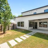 a front view of house with yard and glass windows
