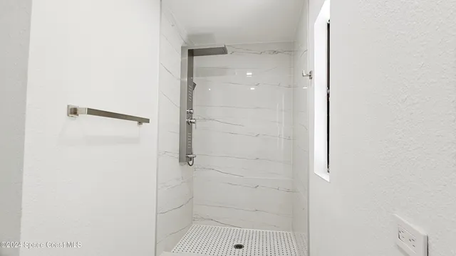 a bathroom with a glass shower door