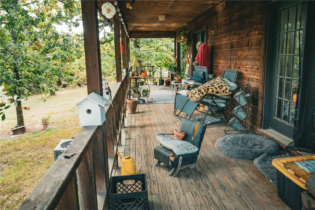 1014 Excelsior Road Greenwood, AR 72936 - Photo 22 of 37 Expansive covered wood-finish porch featuring a wood-paneled exterior wall
