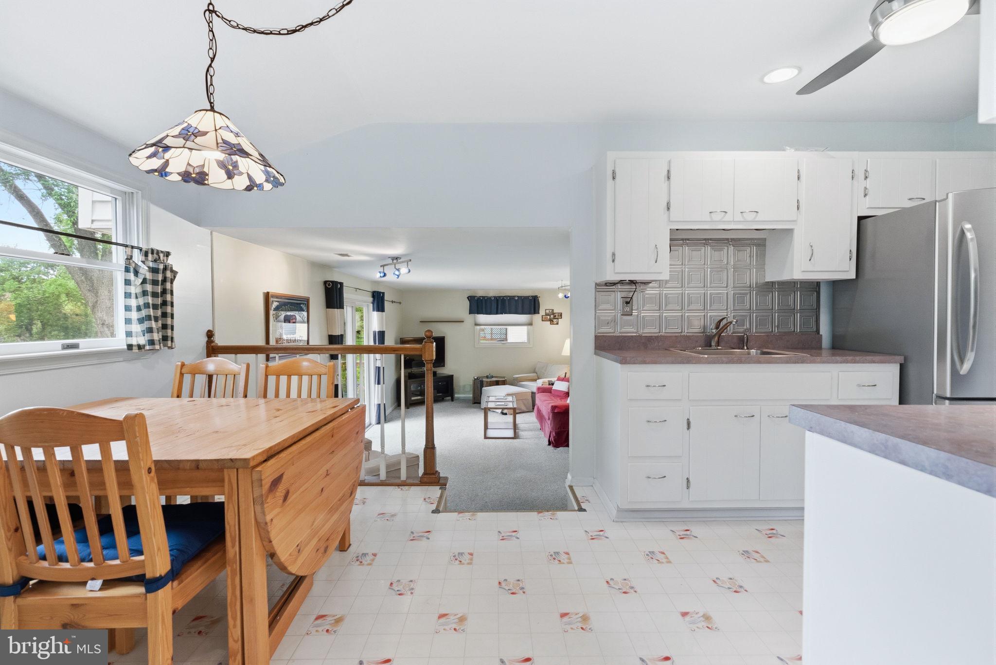 81 Cherokee Road Doylestown, PA 18901 - Photo 6 of 43 a kitchen with stainless steel appliances kitchen island granite countertop a refrigerator a stove a sink dishwasher and white cabinets with wooden floor
