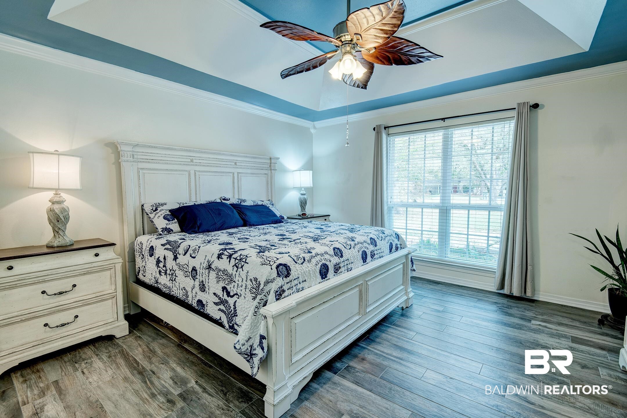 10093 Willis Road Foley, AL 36535 - Photo 8 of 33 Bedroom featuring dark wood-style floors, crown molding, ceiling fan, and a raised ceiling