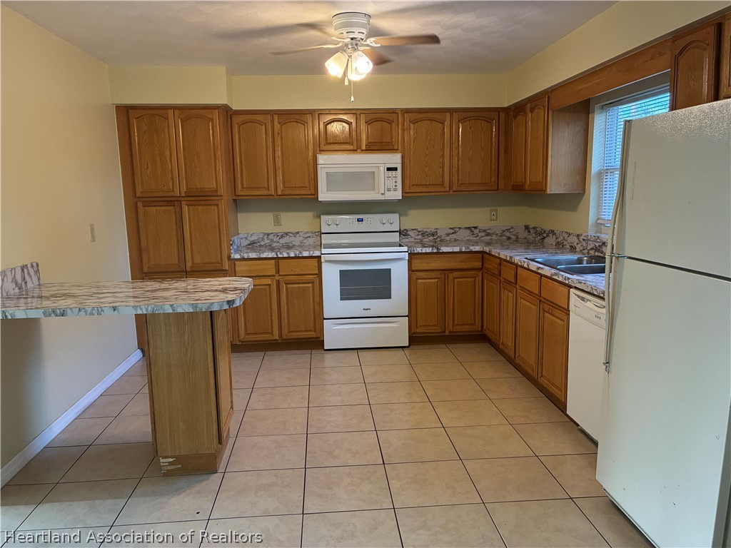 1525 Lagrange Avenue Sebring, FL 33870 - Photo 4 of 16 a kitchen with stainless steel appliances granite countertop a refrigerator and a stove top oven